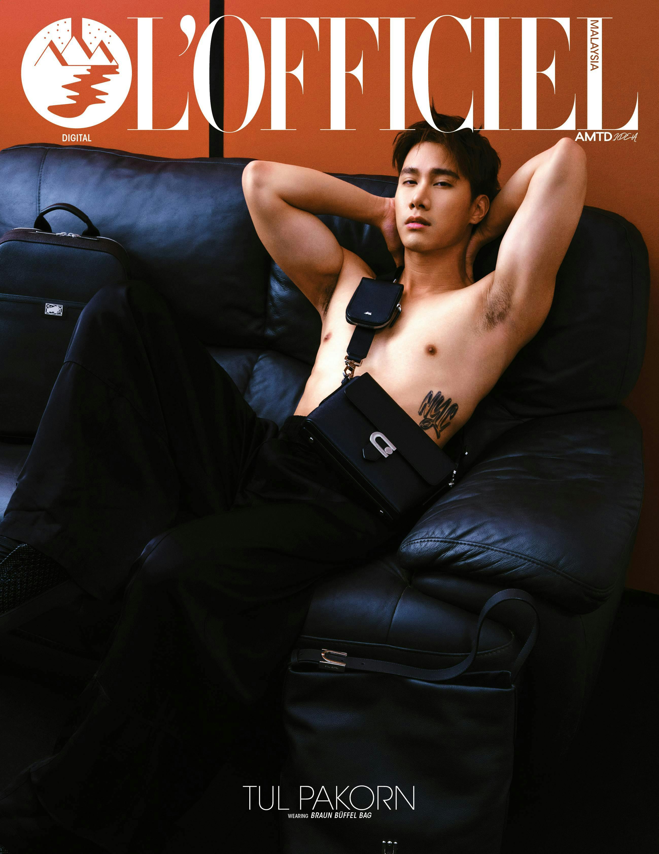 couch furniture adult male man person publication chair skin tattoo